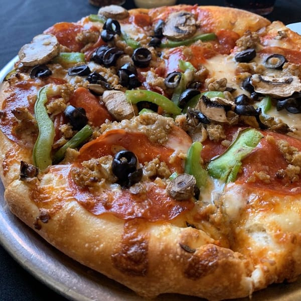 Angelo's Pizza Parlor's supreme pizza with pepperoni, sausage, mushrooms, olives, and green peppers.
