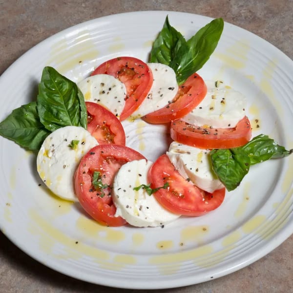 Angelo's Pizza Parlor's Caprese salad with sliced tomatoes, mozzarella, basil, and olive oil.